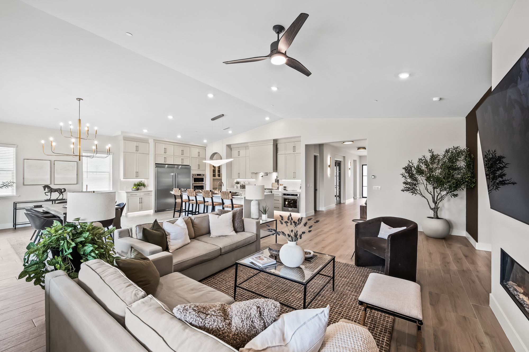 Wide angle of great room, kitchen, and dining area