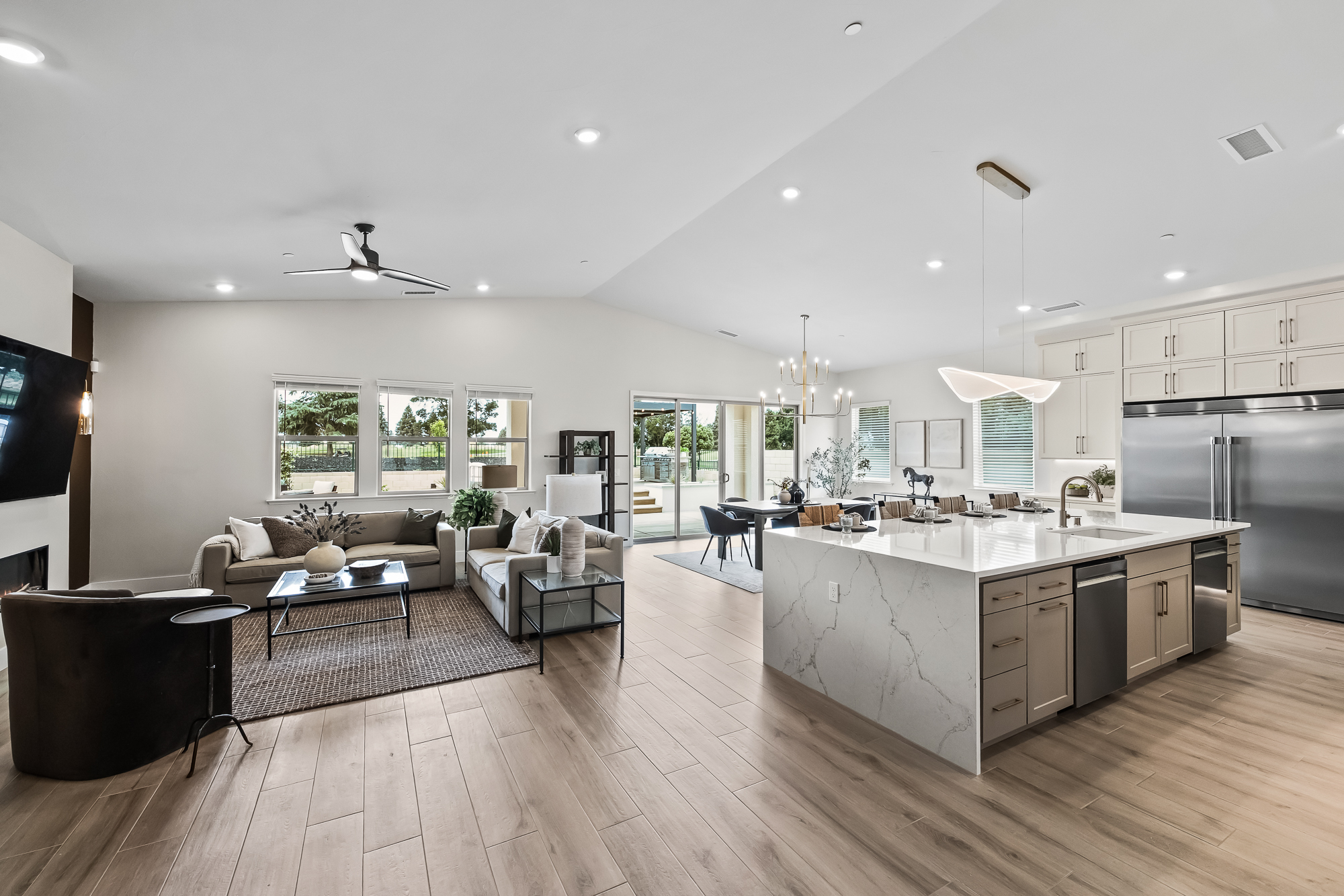 Wide angle of great room, kitchen, and dining area
