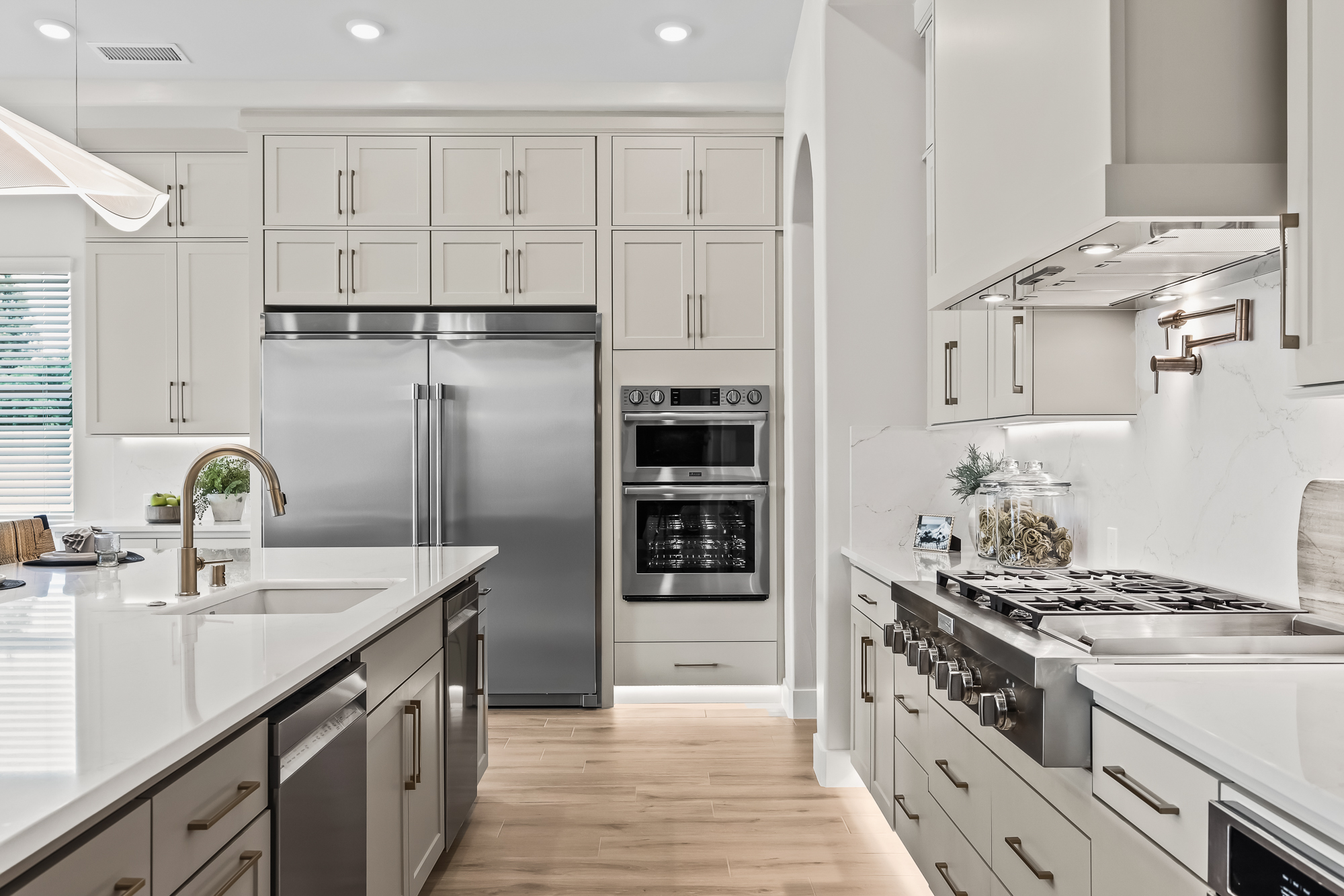 Wide angle of kitchen from behind kitchen island