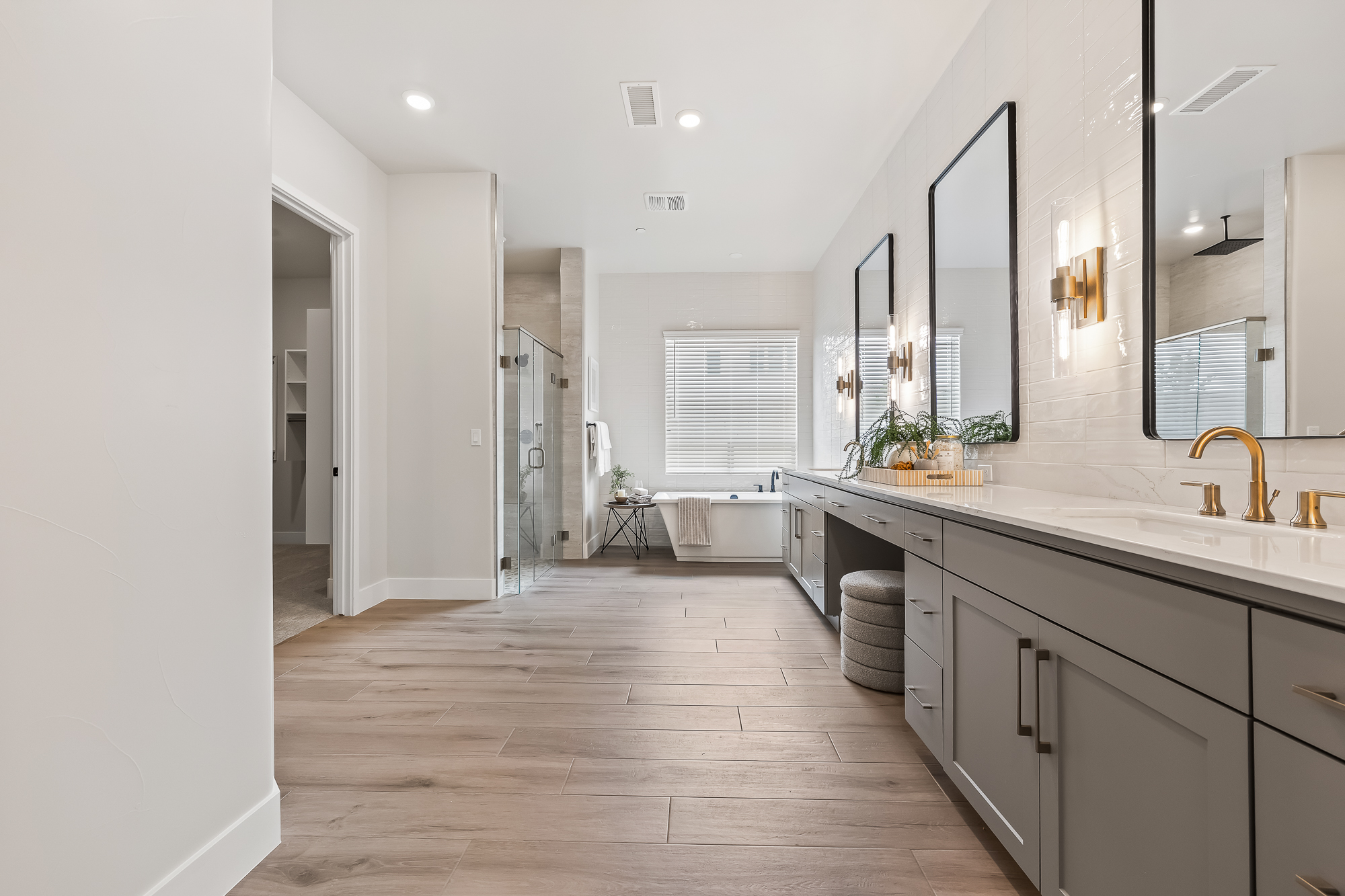 wide angle of owner's bathroom with dual vanity, bathtub, and shower