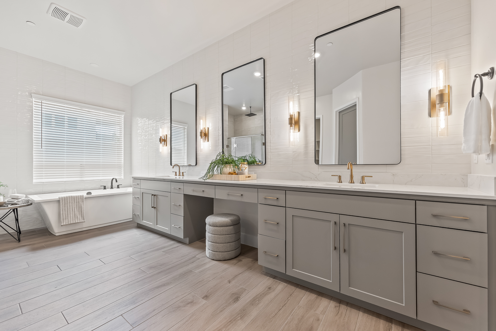 wide angle of owner's bathroom with dual vanity bathtub