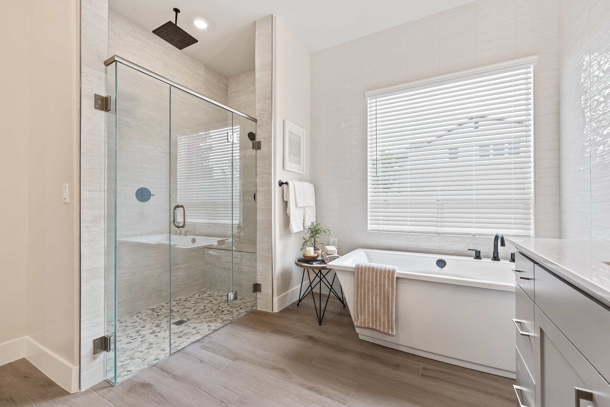 wide angle of owner's bathroom with bathtub and shower