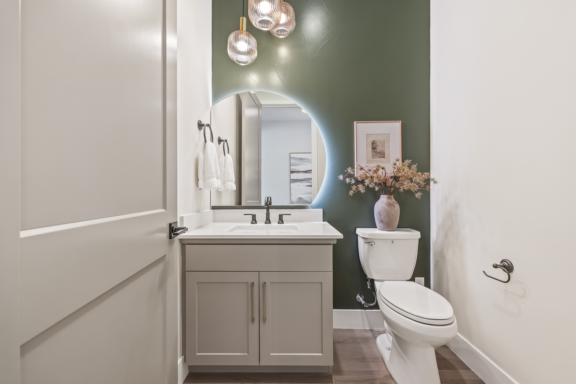 wide angle of powder room with single vanity and toilet