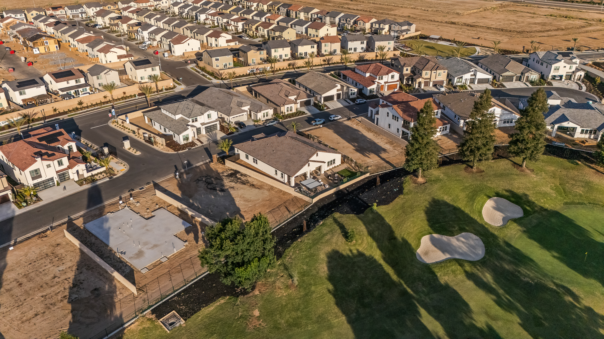 drone shot of the entire house and golf-course