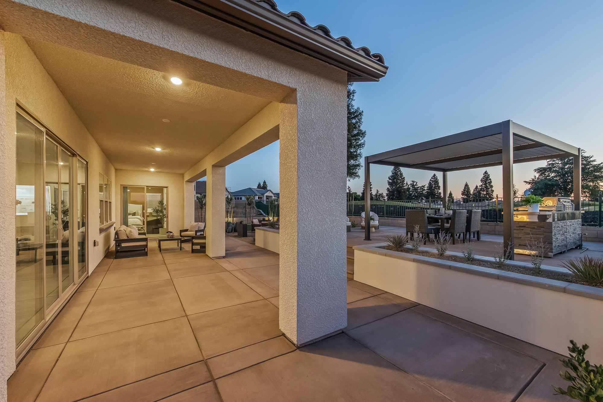 wide angle twilight shot of backyard and covered patio