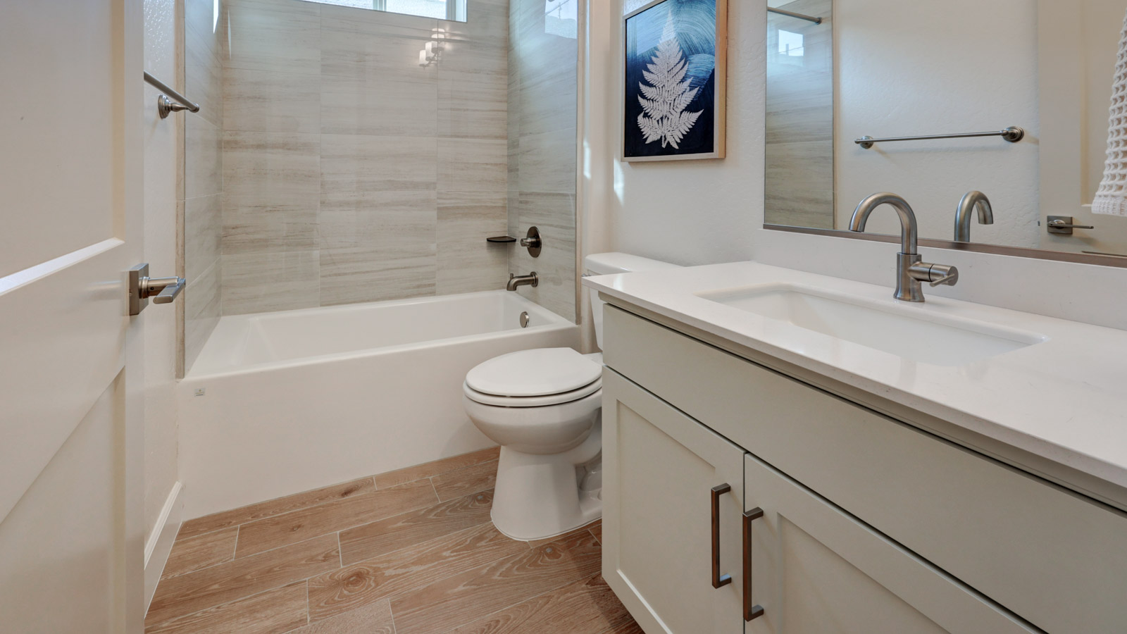 Photo of bathroom sink, bathtub, and toilet