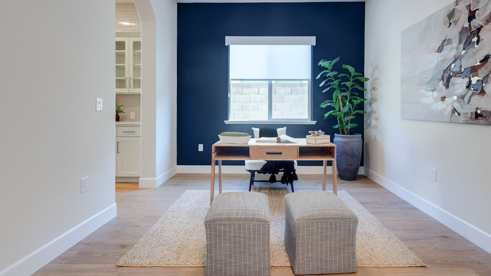 Study with accent wall and window blinds