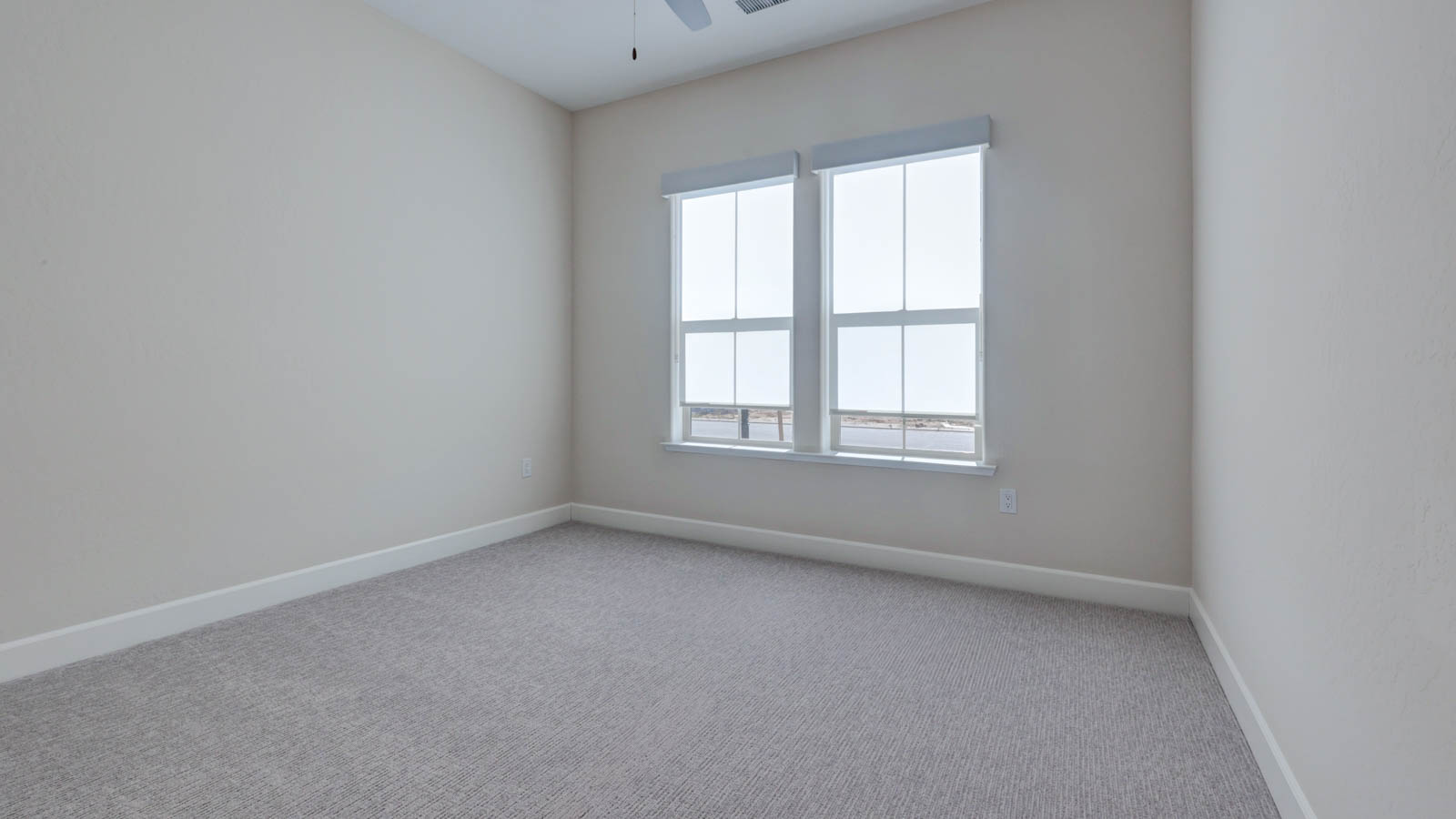 Bedroom with carpet and window blinds