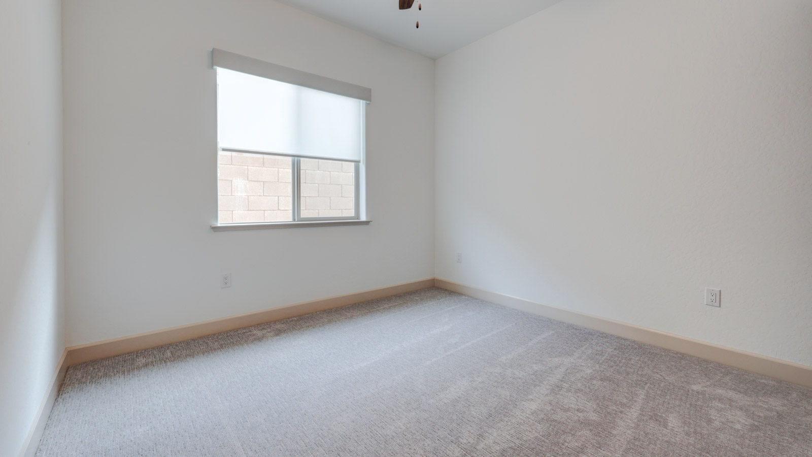 Bedroom with carpet and window blinds