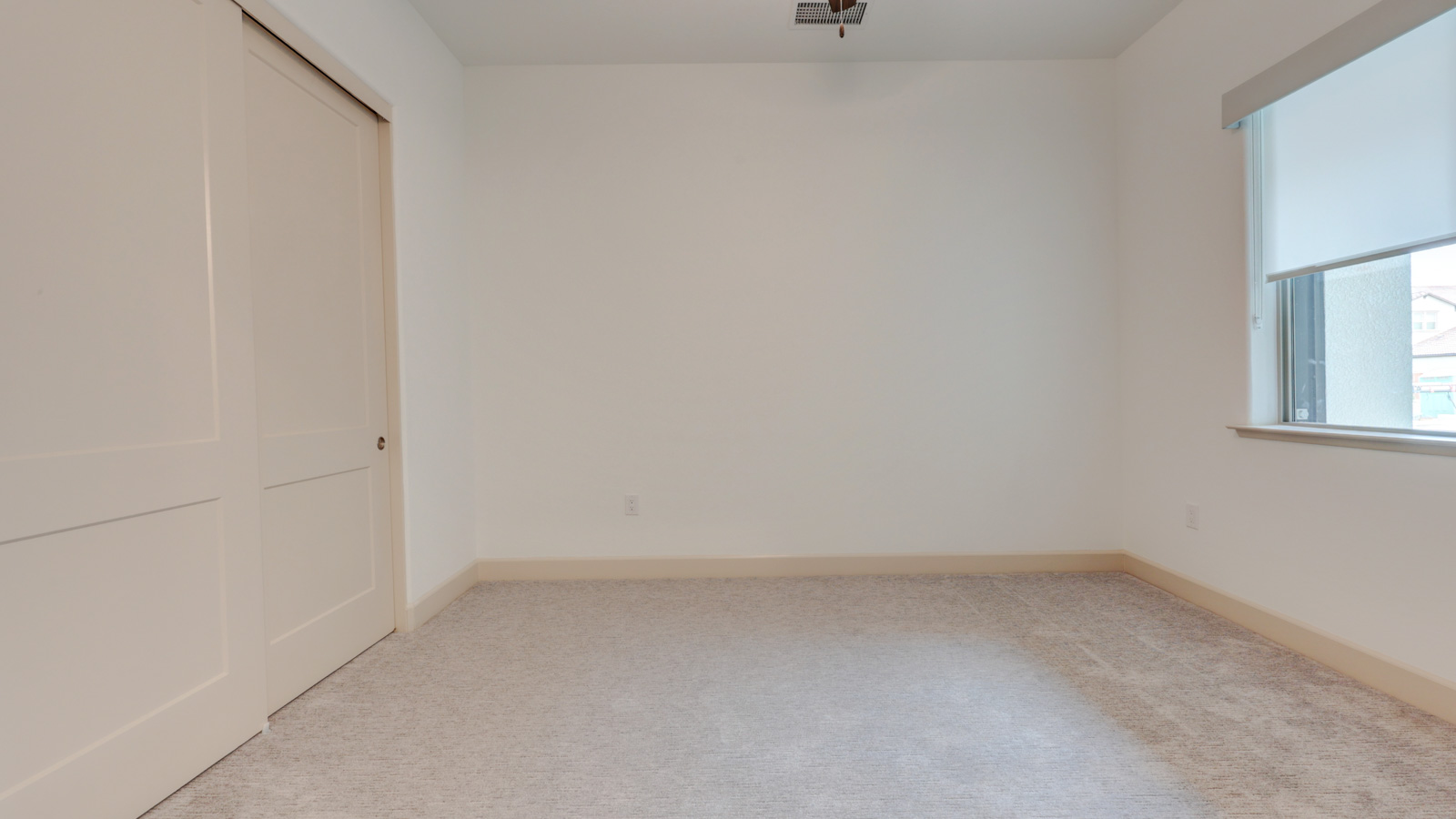 Bedroom with carpet and window blinds and adjoining bath