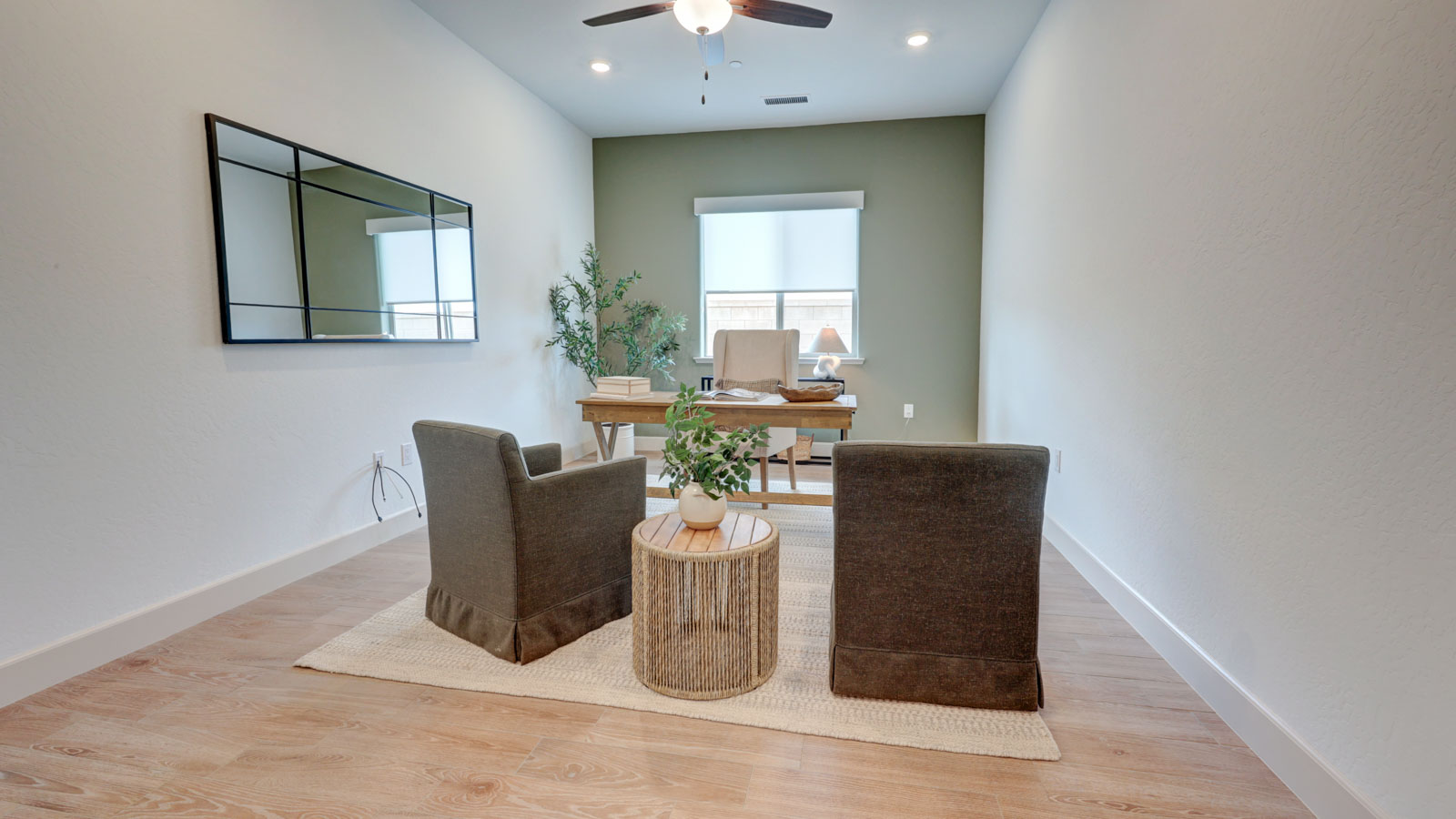 Study with accent wall, plank tile flooring and blinds.