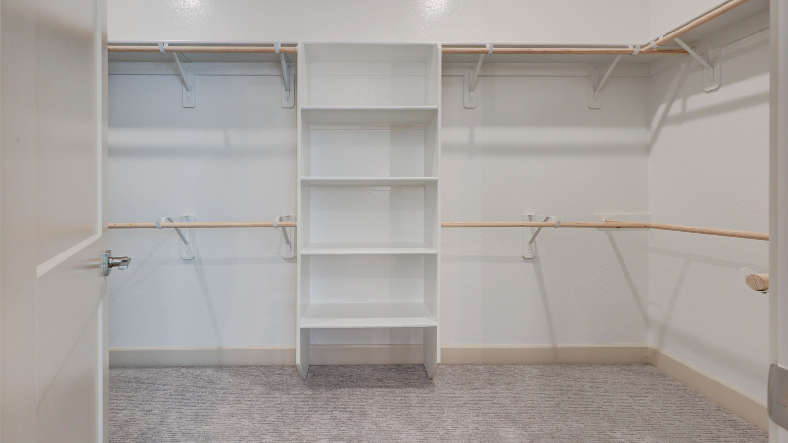Large wardrobe with doors to laundry room and master suite.