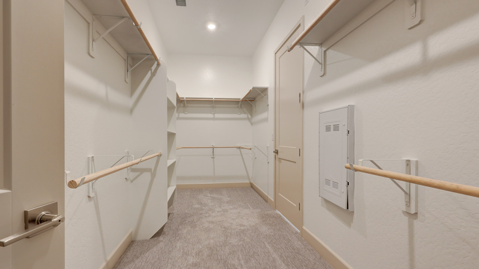 Large wardrobe with doors to laundry room and master suite.