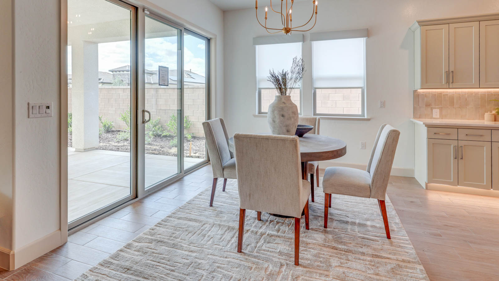 Dining nook with sliding door to rear yard and plank tile flooring.