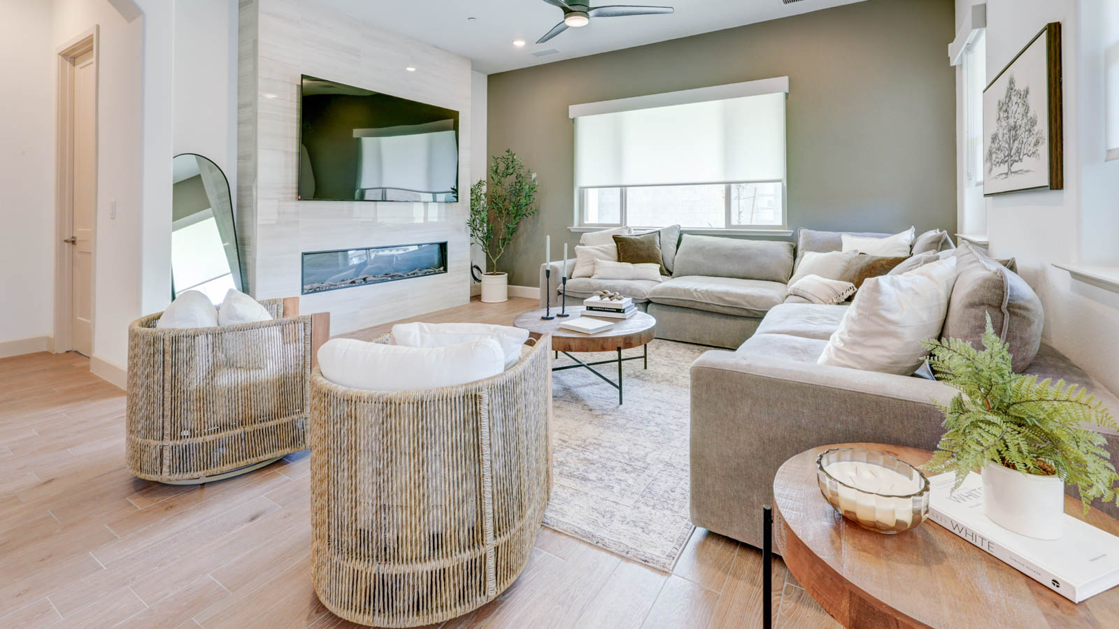 Great room with TV above electric fireplace.