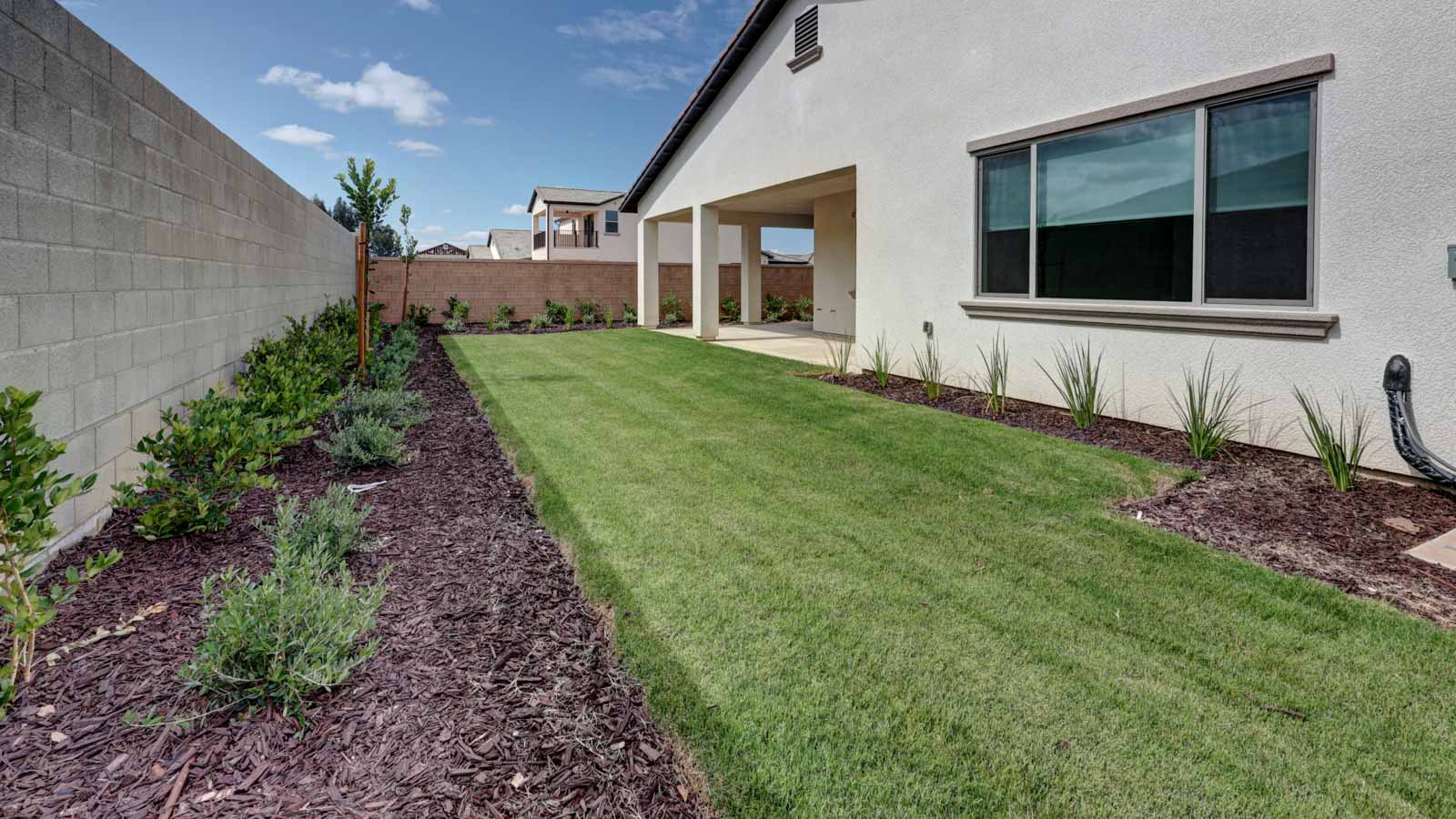Fully landscaped rear yard and large covered patio.