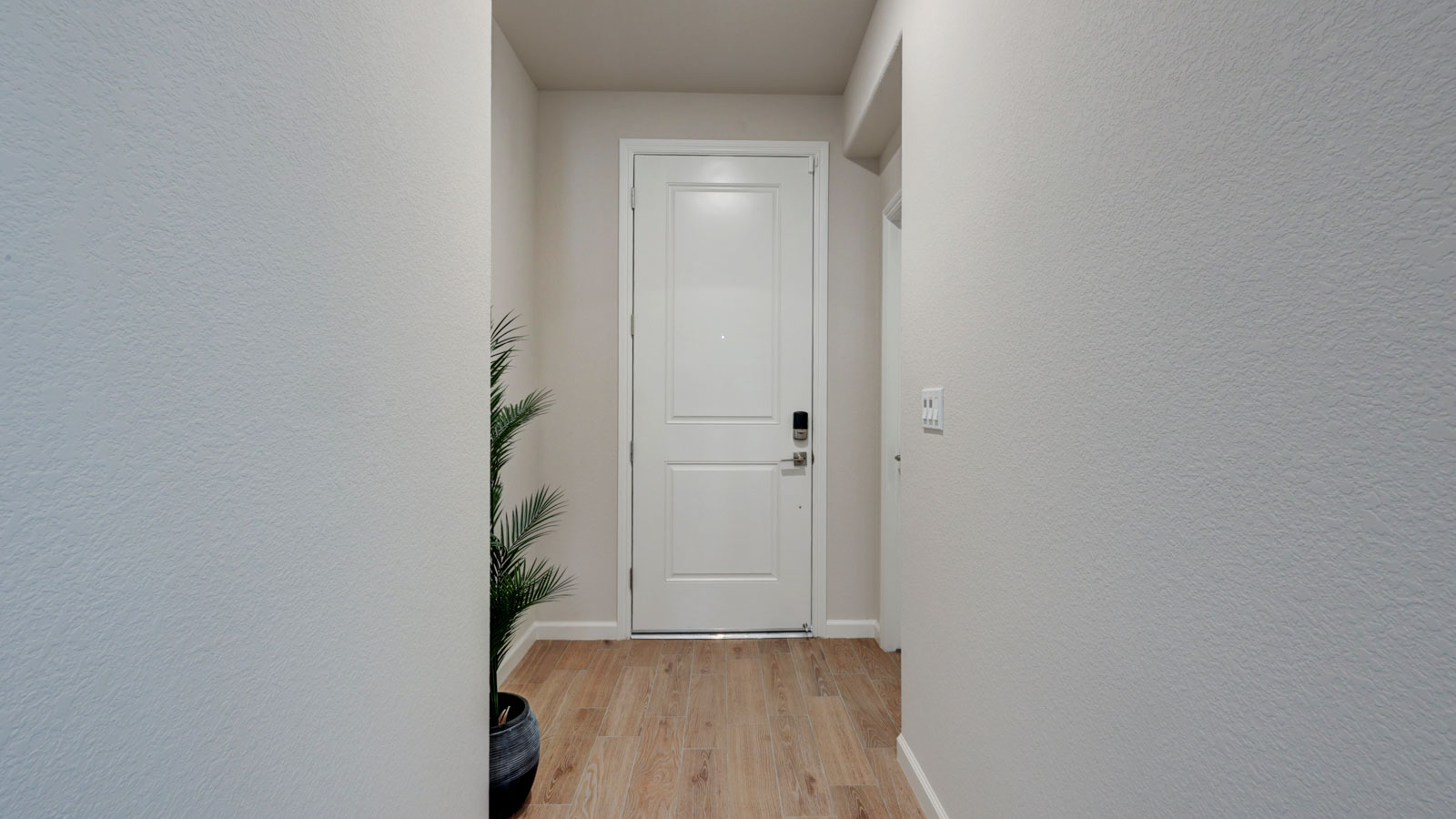 Entry with 8'tall door and tile flooring