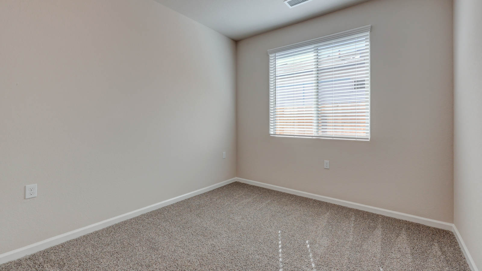 Bedroom with one window and carpeting