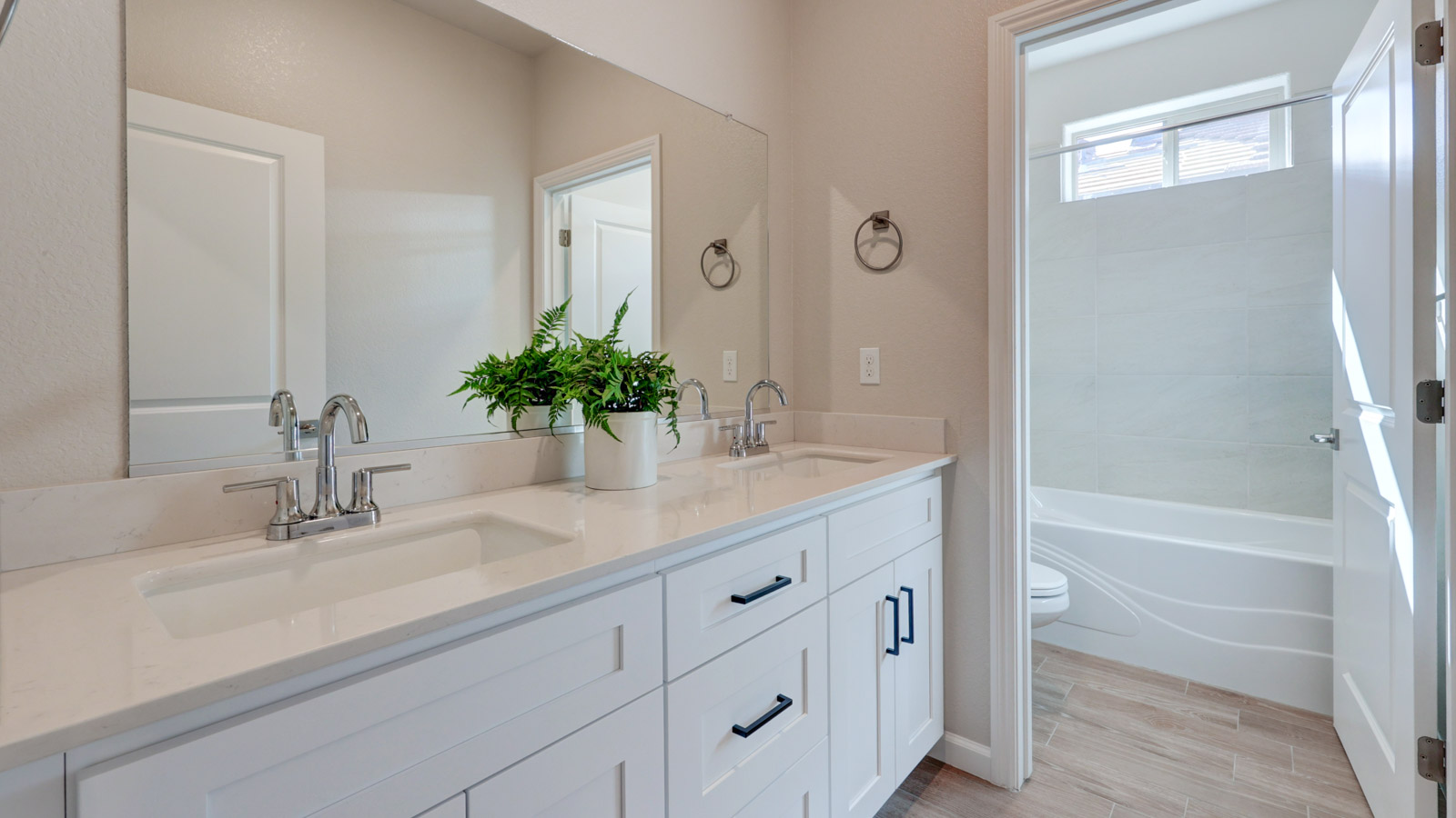 Bath with double sink and separate area with sink and commode