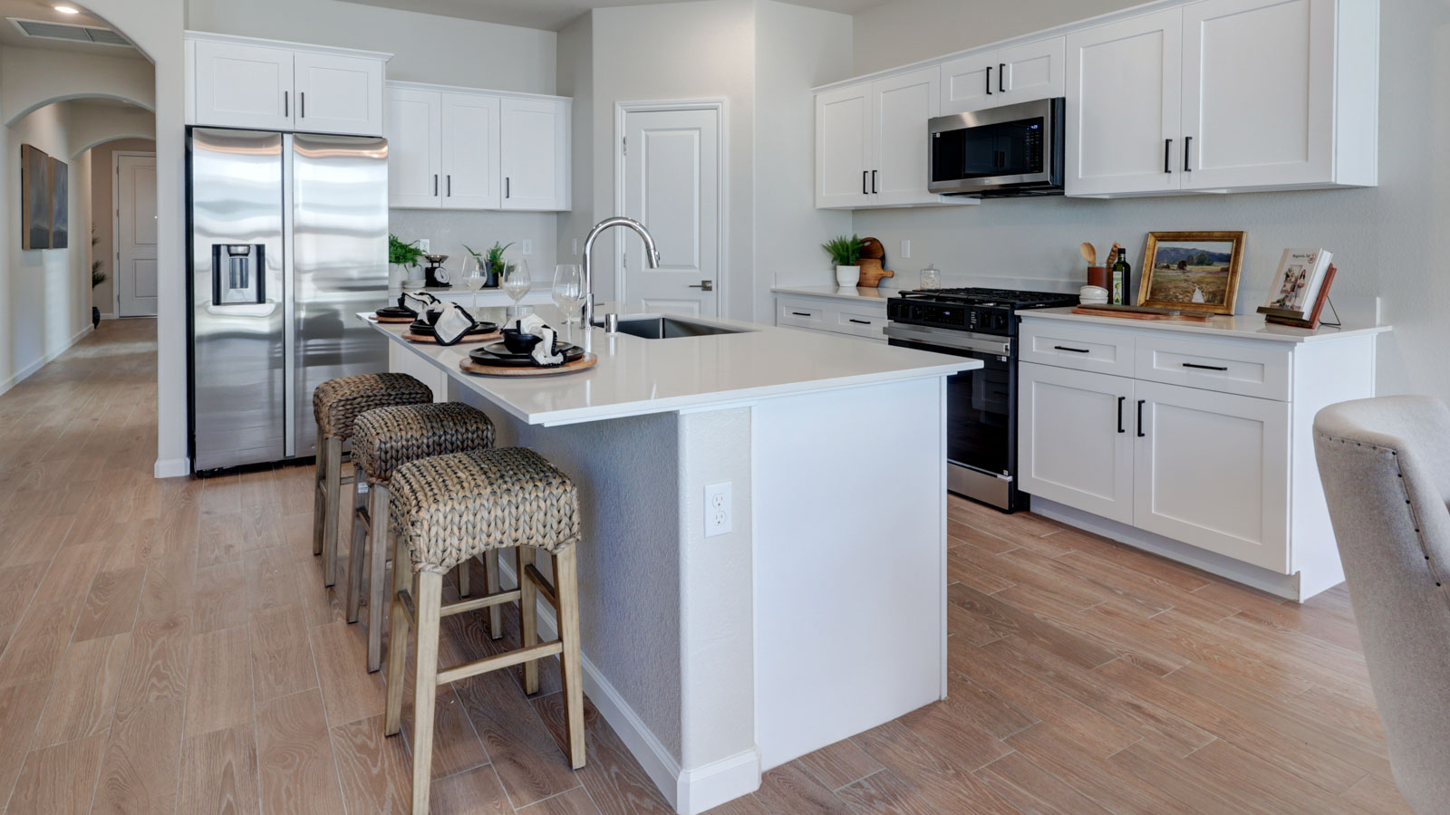 Kitchen w/island, white cabinets and tile flooring
