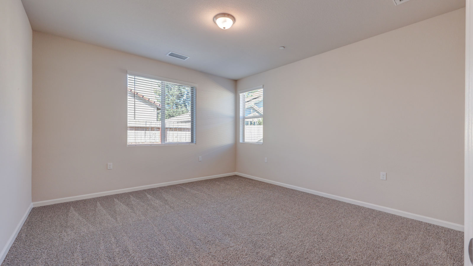Owner Suite with two windows and carpeting