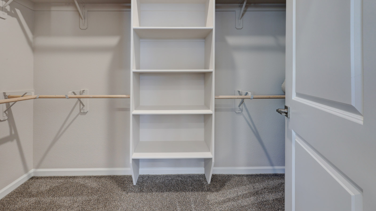Owners walk-in closet with double pole and shelving