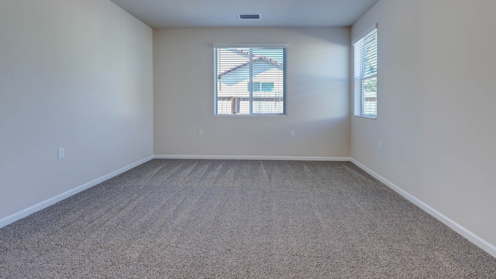 Owner Suite with two windows and carpetin