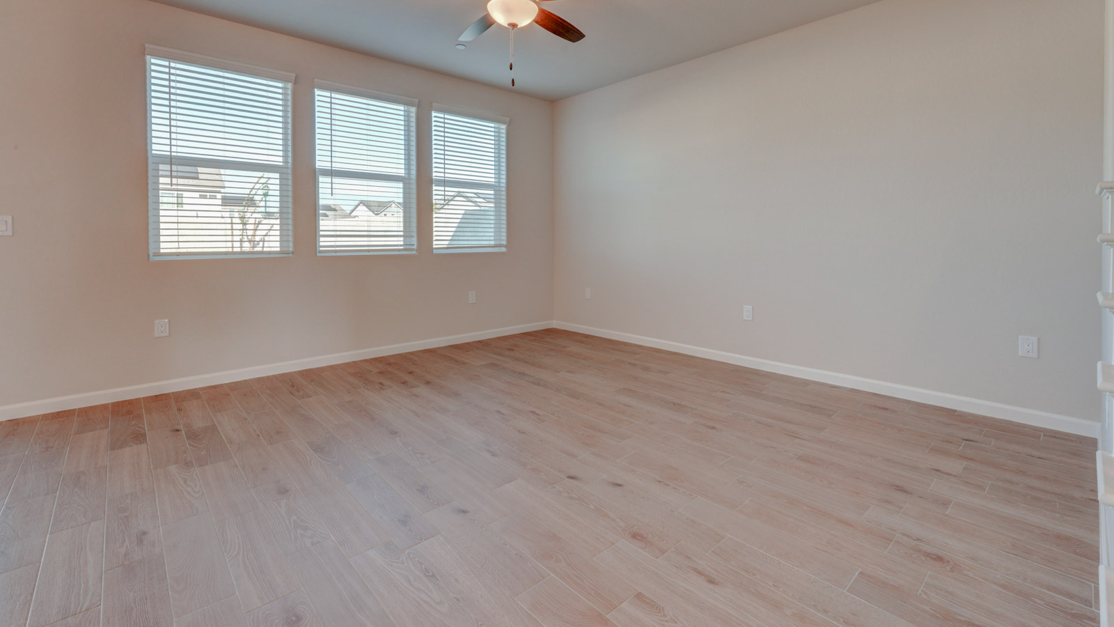 Great Room with three windows and tile plank flooring.