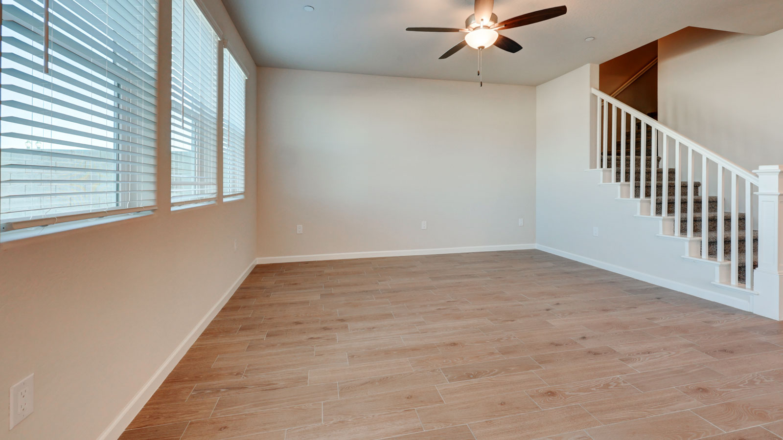 Great Room with three windows and tile plank flooring.