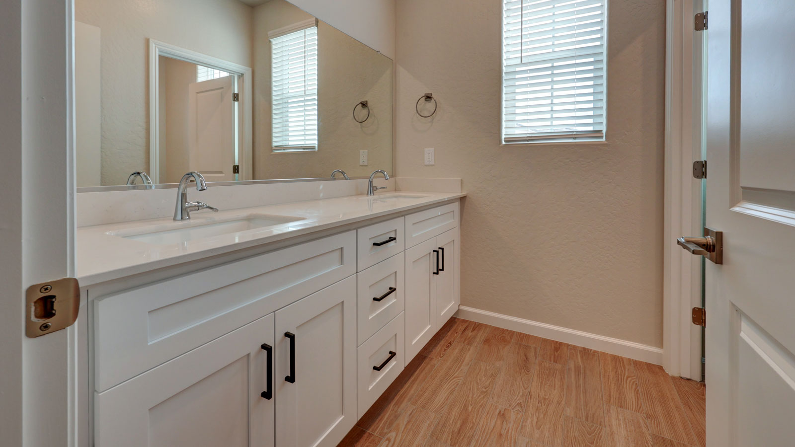 Bath 2 with dual sinks and tile flooring