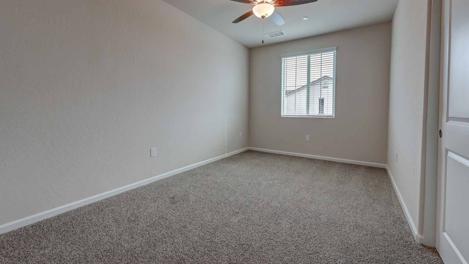 Bedroom 2 with blinds and carpeting