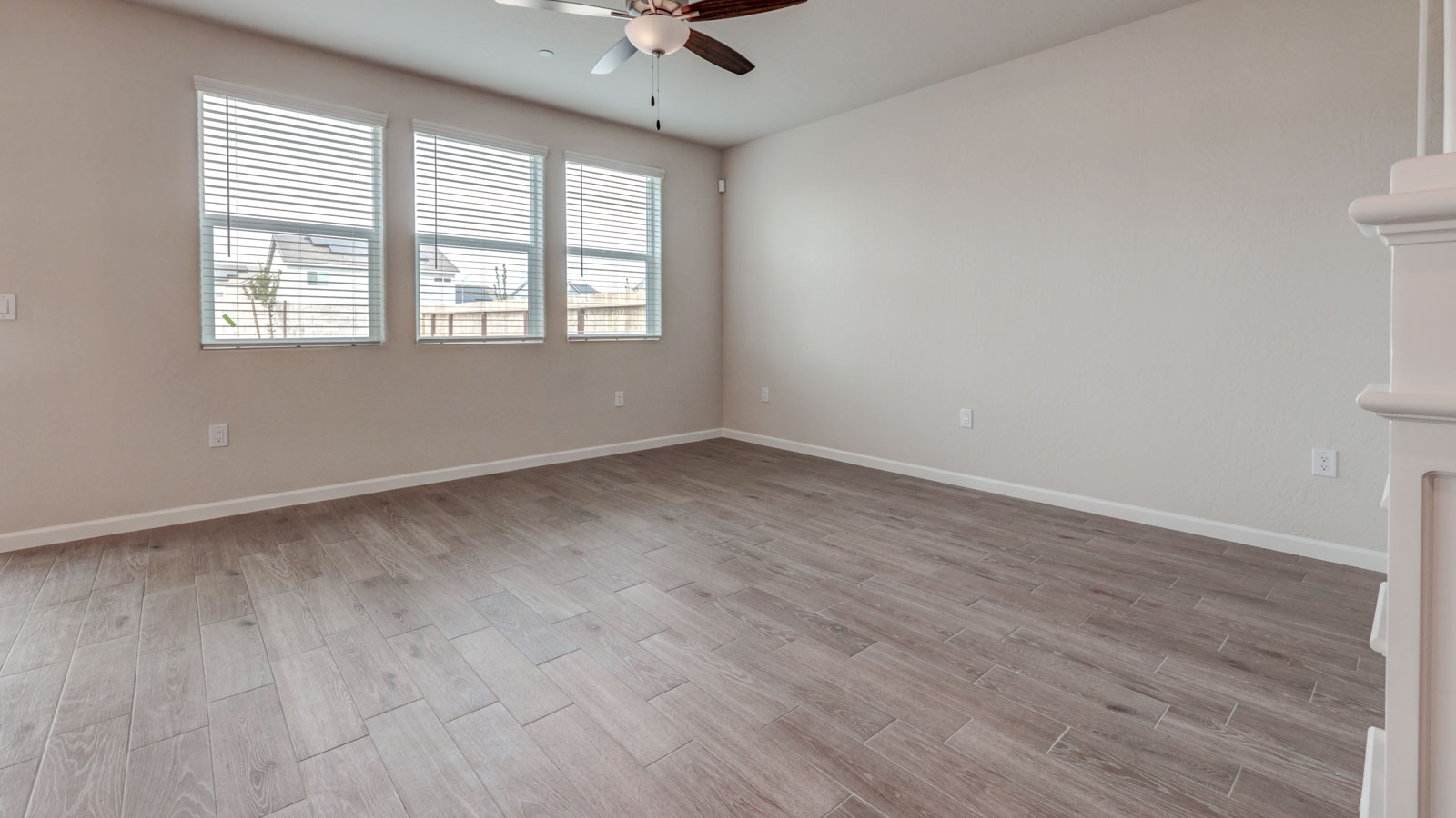 Great Room with 3 windows with blinds and tile flooring