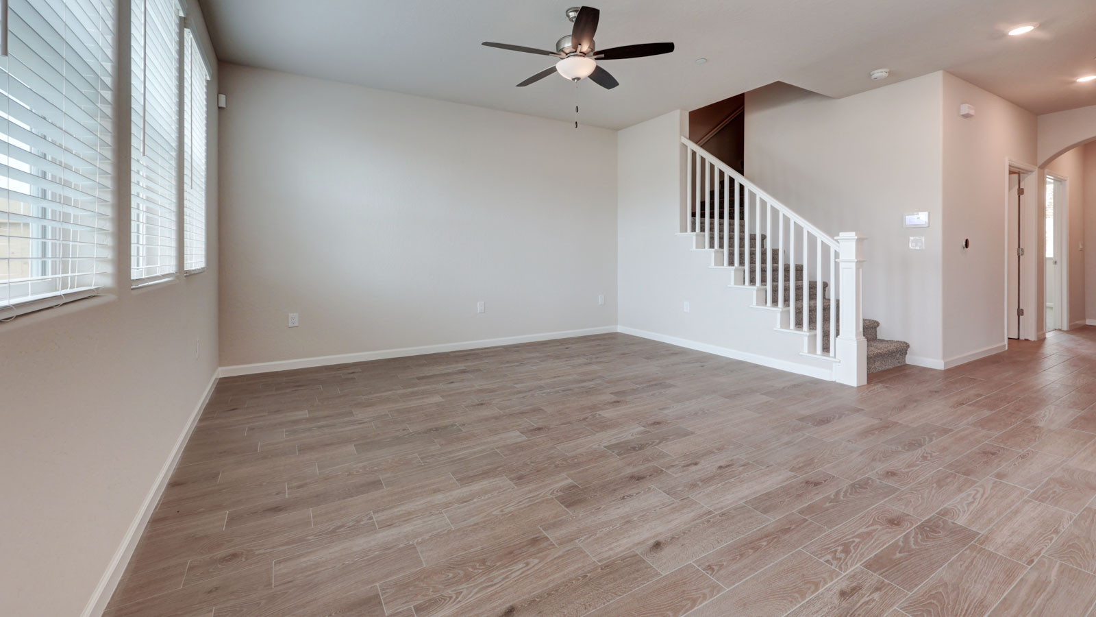 Great Room with 3 windows with blinds and tile flooring