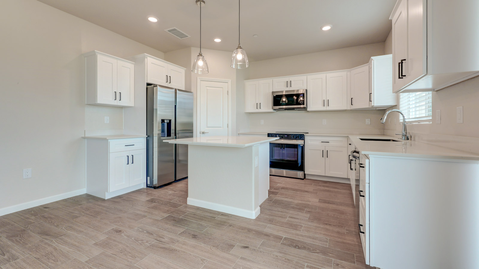 Kitchen with white cabinets, walk-in pantry and tile flooring