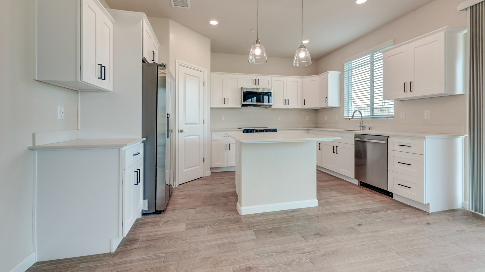 Kitchen with white cabinets, walk-in pantry and tile flooring