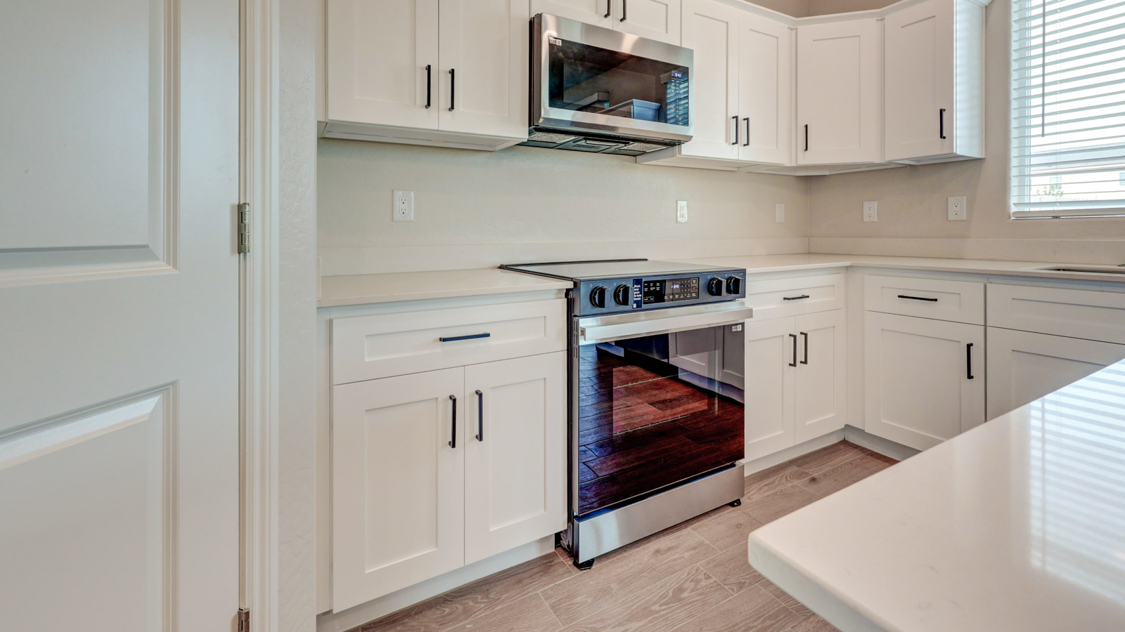 Kitchen with white cabinets, walk-in pantry and tile flooring