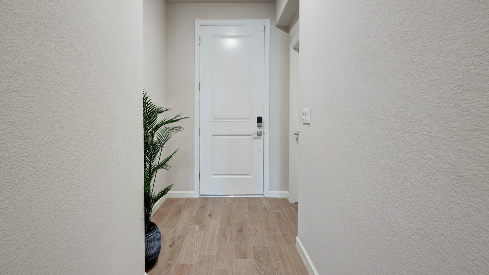 Entry with plank tile flooring. Fiberglass door with Kwikset WiFi lock