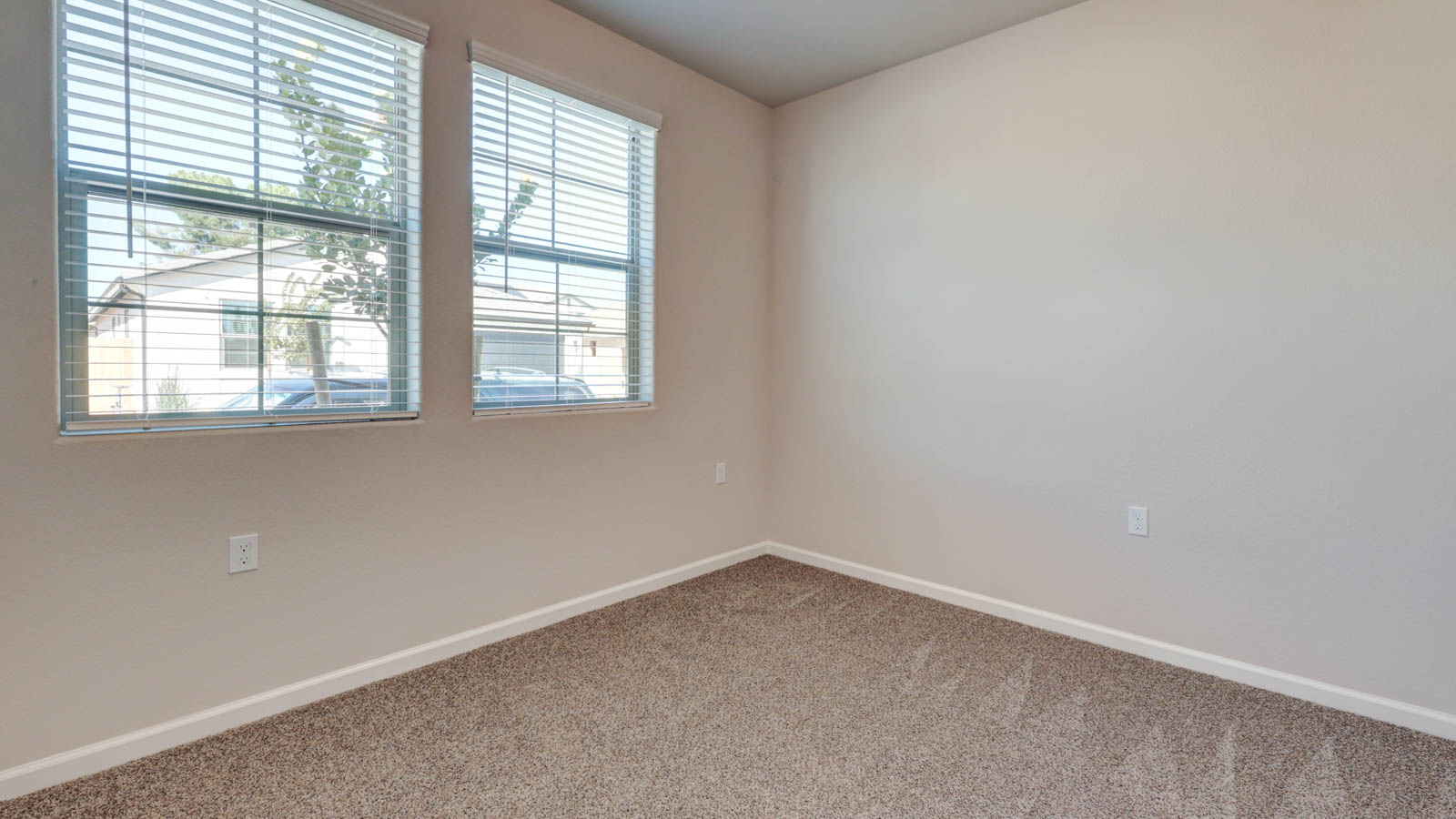 Bedroom with carpeting and blinds