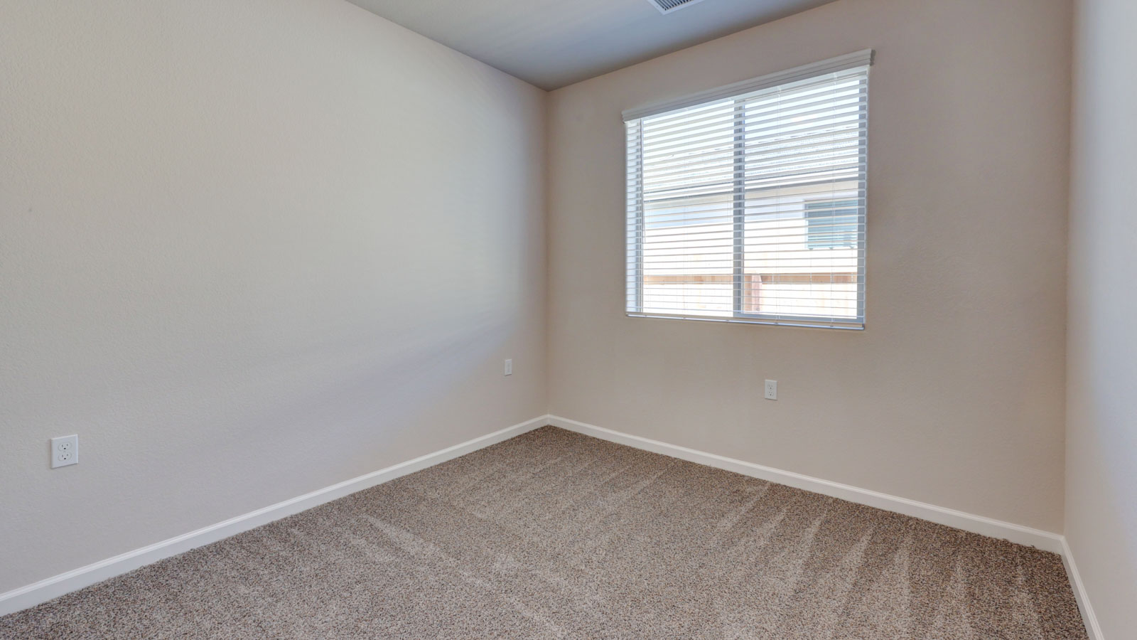 Bedroom with carpeting and blinds