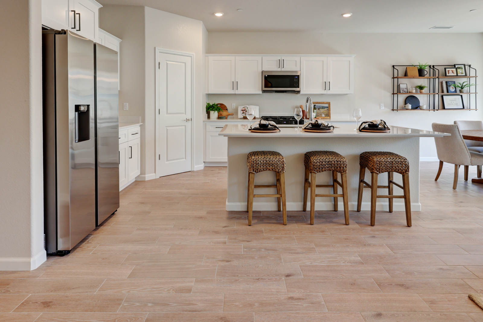 Kitchen with tile flooring, island and corner pantry